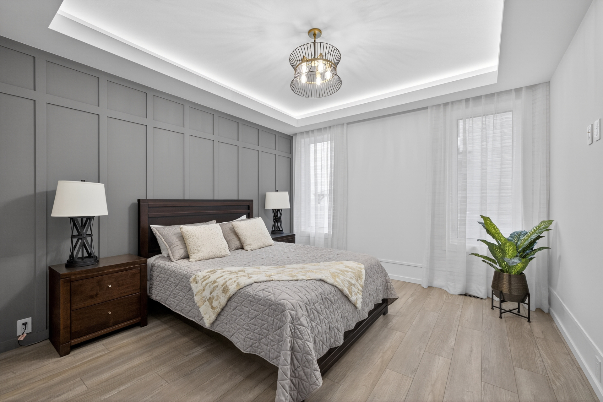 Main-floor primary master suite with coffered ceiling and board-and-batten feature wall