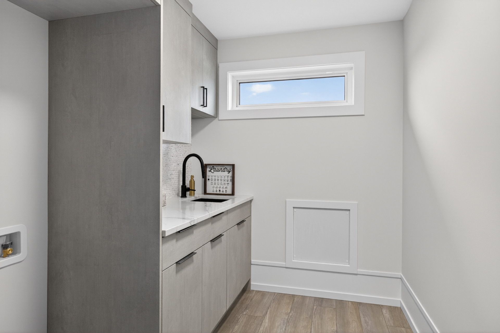 Upper Laundry — Sink, quartz counter and built-in storage where the laundry happens