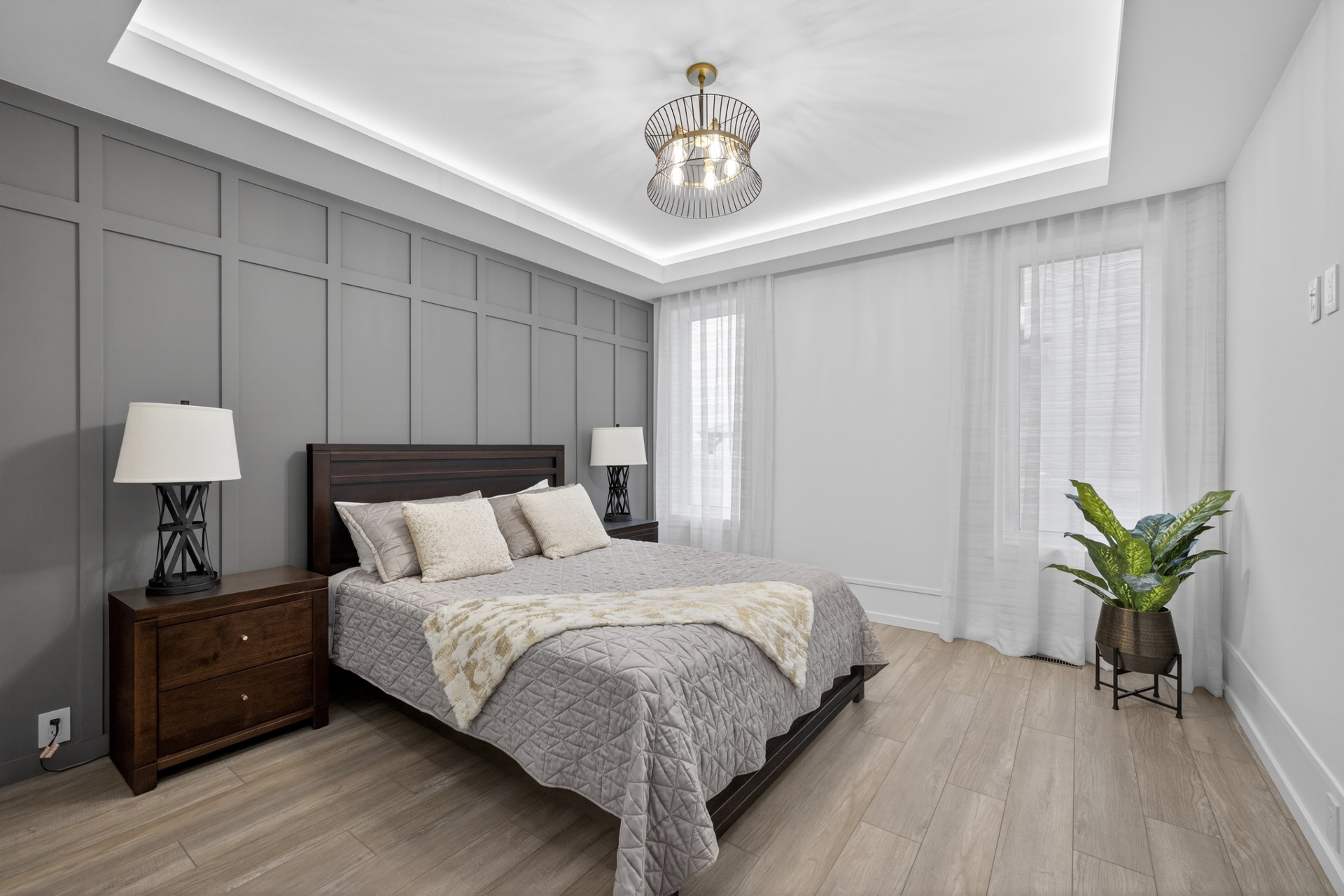 Main-floor parents' retreat with a coffered ceiling and board-and-batten feature wall