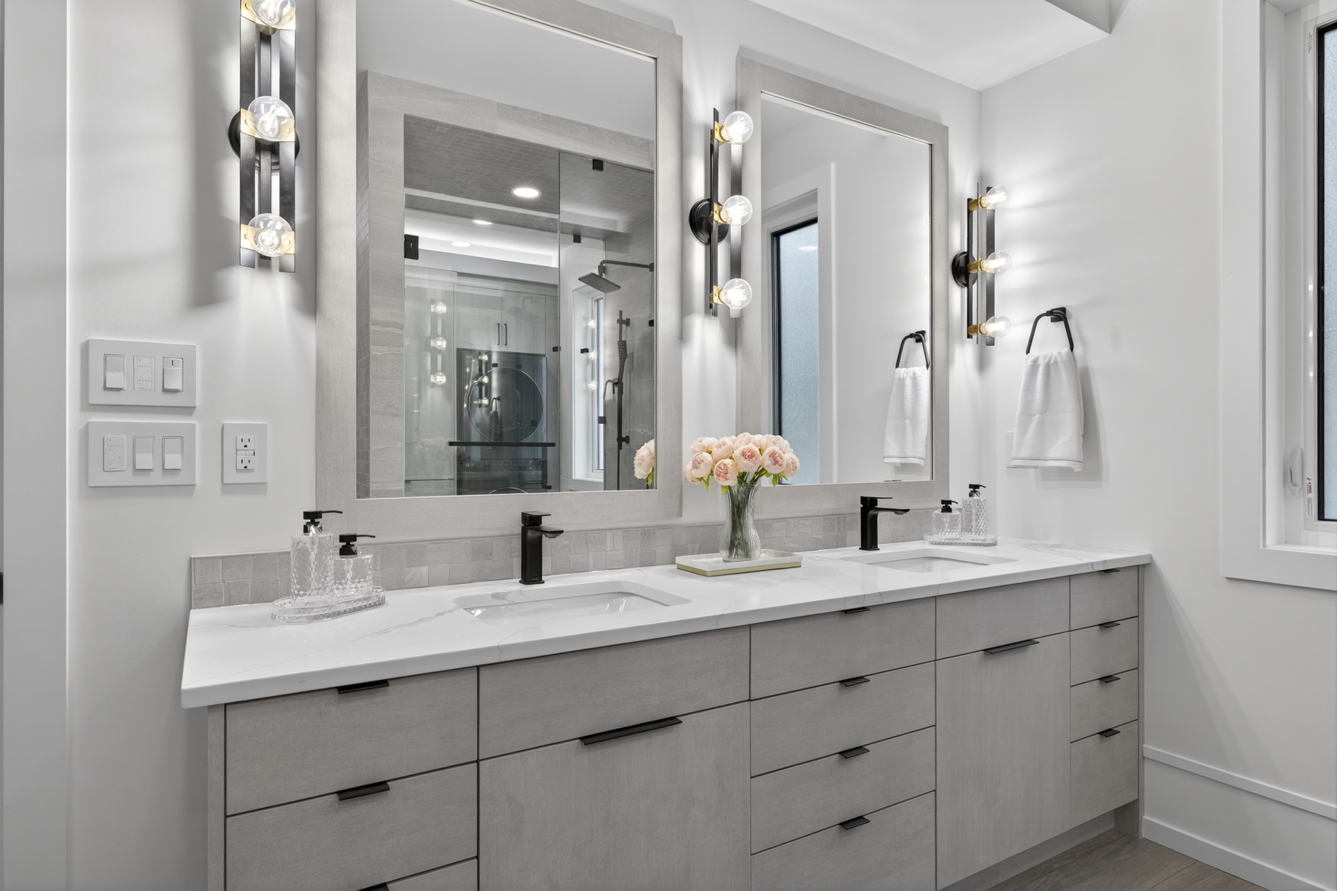 Spa-grade ensuite with double vanity, quartz counters, and matte black fixtures